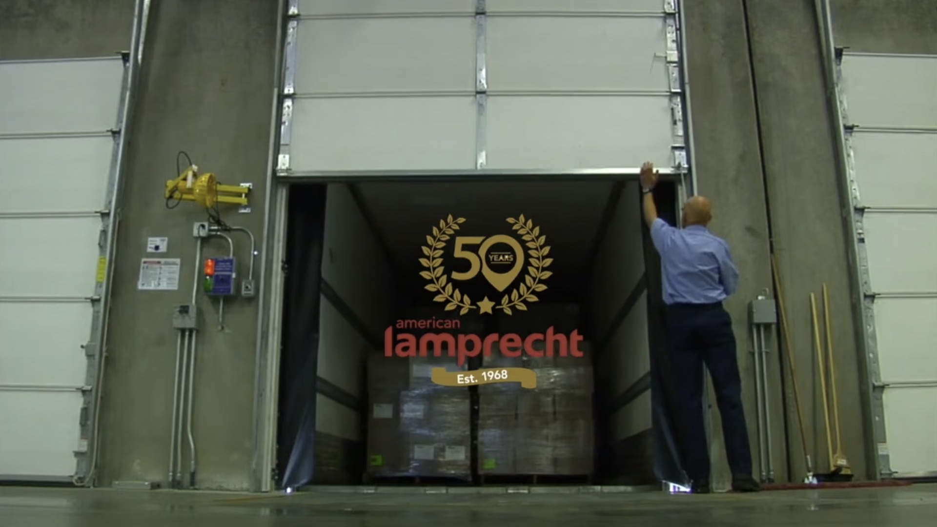American Lamprecht 50-year anniversary identity over a warehouse loading-door scene.