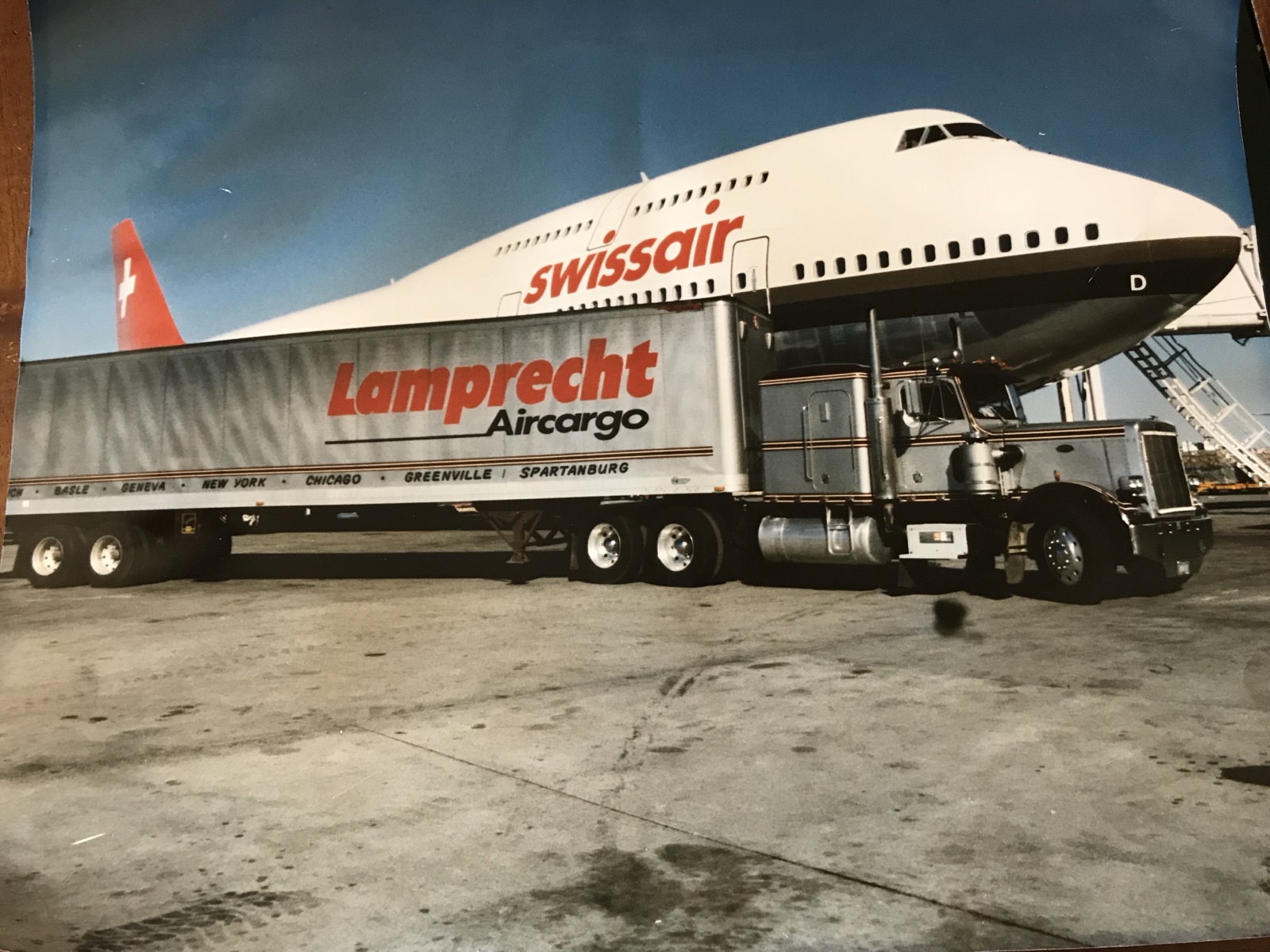Photograph of historical Lamprecht Aircargo imagery showing a truck beside a Swissair aircraft.